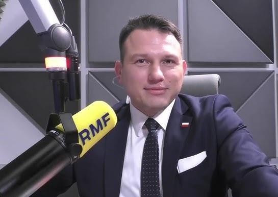 Alt: Sławomir Mentzen przemawiający z energią na wiecu politycznym, z tłumem zwolenników w tle, symbolizującym jego rosnące poparcie polityczne.